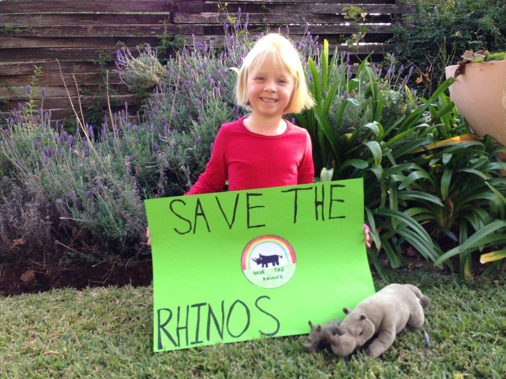 Picture of Alyssa Carter with her Save the Rhinos poster