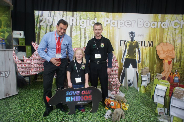 Alyssa Carter proudly displays a Save our Rhinos board with Graphix Supply World MD and Dad Brian.