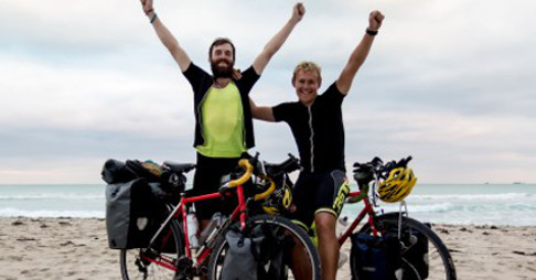 Will Frazer and Johan du Plessis celebrating the completion of their Riding for Rhinos effort on a beach in Miami.