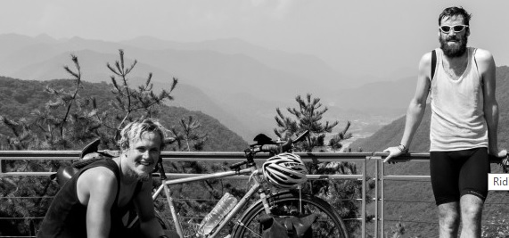 Will Frazer and Johan du Plessis posing on the side of the road during their Riding for Rhino's effort.